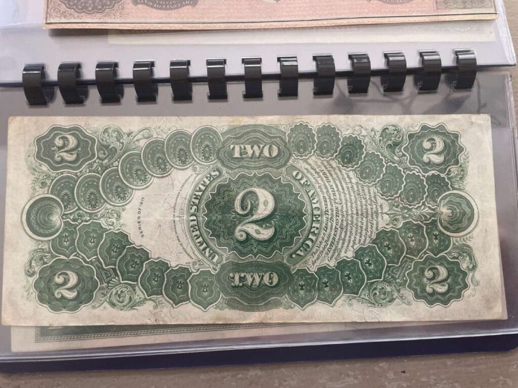 Your Ultimate Guide To $2 Bills Worth Money 1 Detailed back view of rare $2 bills, highlighting the historical scene of the signing of the Declaration of Independence.