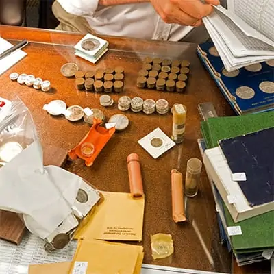 Sell Coins in Lubbock With Coinfully - Sell Gold Coins - Gold coins laid out on table for sale in Lubbock.